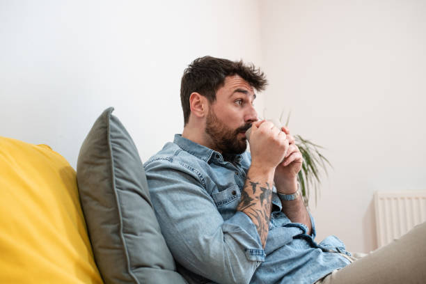 istock Handsome young man drinking tea at home 1395202054