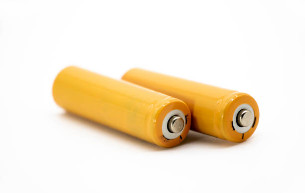 yellow AA size batteries isolated on white background, close up stock photo