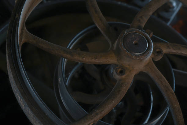 Wool Mill Flywheels III Flywheels in an abandoned wool mill. fly wheel stock pictures, royalty-free photos & images