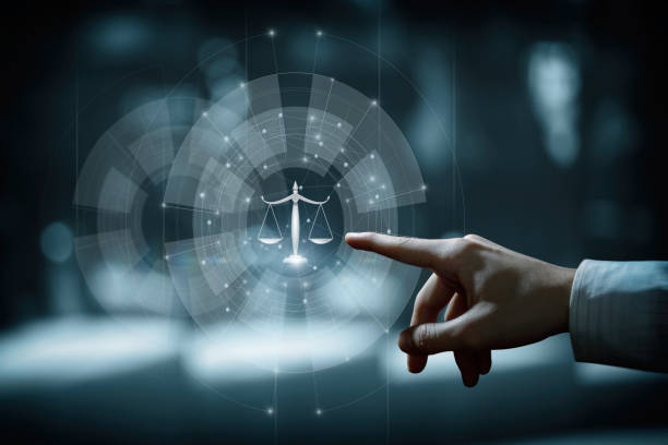 istock Hand clicks on scales of justice. 1395205795