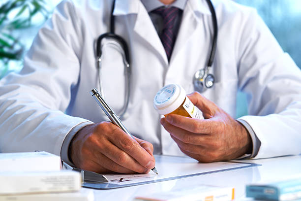 Doctor writing out RX prescription stock photo