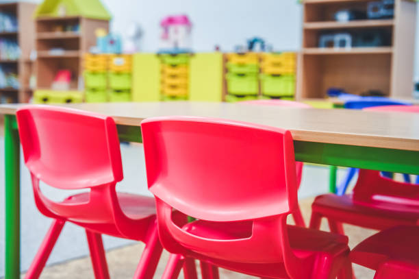 istock Chairs, table and toys. Interior of kindergarten. 1395209446