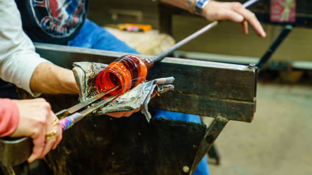 Glassblowing class Making a colorful glass in a glassblowing studio hand blown glass stock pictures, royalty-free photos & images