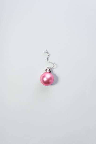 istock christmas pink ball minimalism on a blue background 1395211155