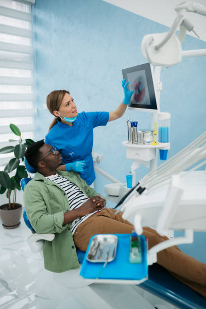 A professional dentist explaining the situation her patient stock photo