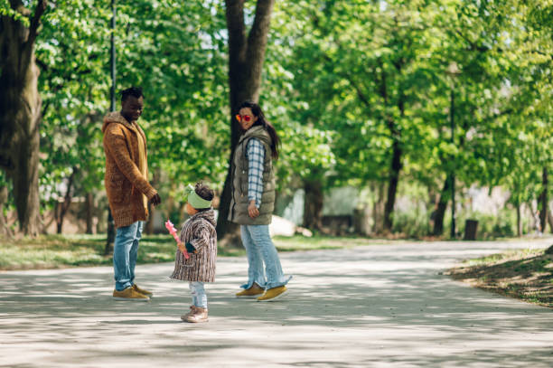 istock Multiracial family having fun in the park 1395213895