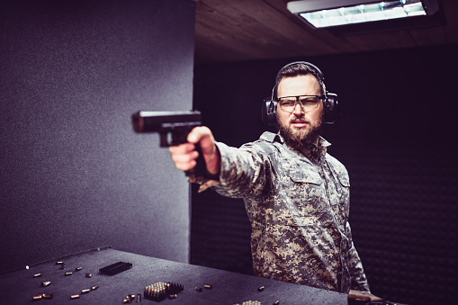 Soldier Practicing One Handed Shooting Technique On Gun Range