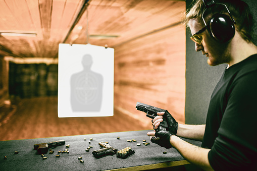 Male Shooter Testing Best Firearm For The Job On Range