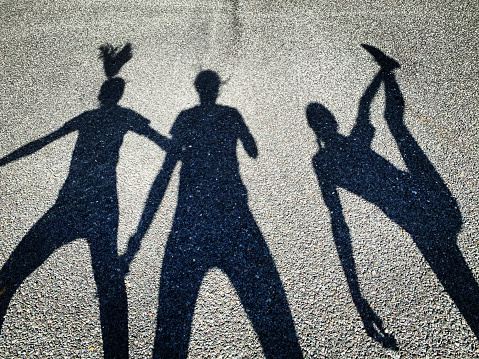 Shadows of mother and daughters exercising together