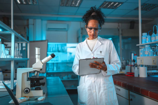 istock Attractive Biracial Female Scientist Taking Notes 1395215307