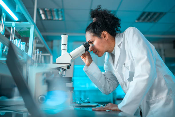 istock Beautiful Biracial Female Scientist with a Microscope 1395216204