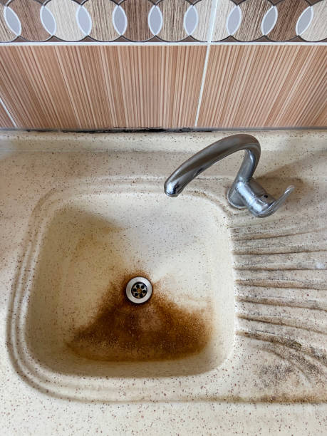 istock Old and weathered kitchen sink and faucet 1395216355