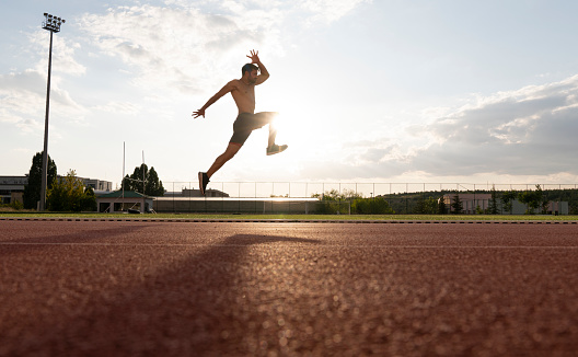 New champion. Full length of young man in sports clothing jumping against