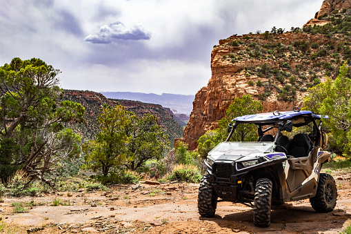 4x4 Side-by-Side off-road vehicle, UTV ATV with a beautiful mountain range in the background near the Colorado and Utah border.