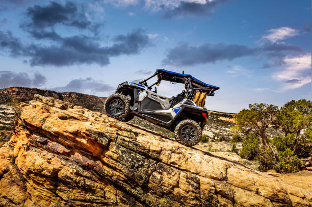 4x4 Side-by-Side off-road vehicle, UTV ATV with a beautiful mountain range in the background near the Colorado and Utah border. 4x4 Side-by-Side off-road vehicle, UTV ATV with a beautiful mountain range in the background near the Colorado and Utah border. side by side stock pictures, royalty-free photos & images