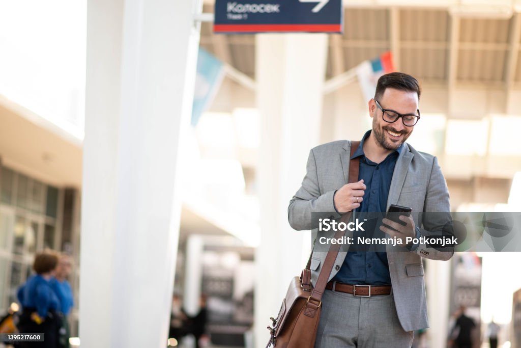 Young handsome businessman with smart phone Young handsome businessman with smart phone in train station London Underground Stock Photo