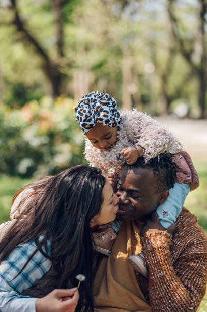 istock Multiracial family having fun in the park 1395218975
