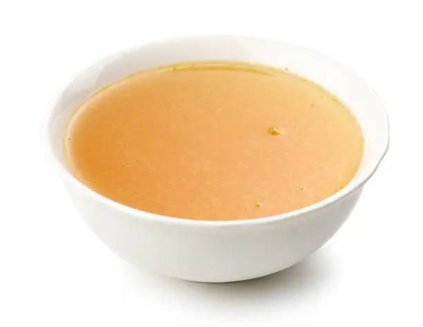 bowl of chicken broth isolated on white background