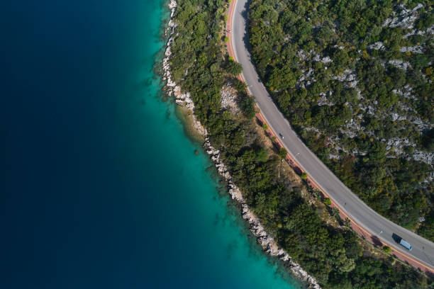 istock Seaside road approaching a beach, seen from above 1395220306