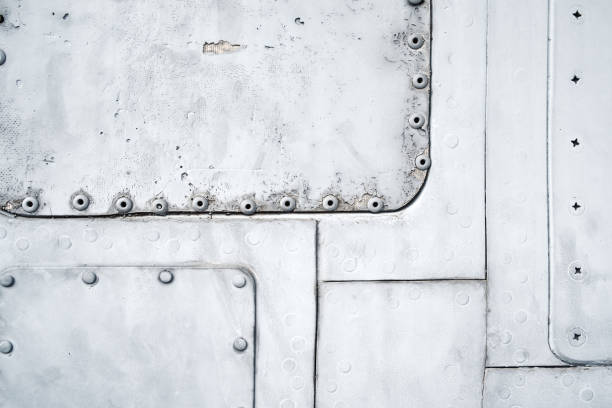 istock Close-up blue painted metal sheets with screw and rivets, background texture, dots, part of old plane 1395221114
