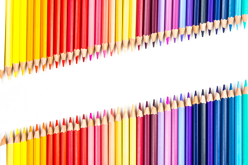 Multi-colored wooden sticks Wooden colouring pencils on white background