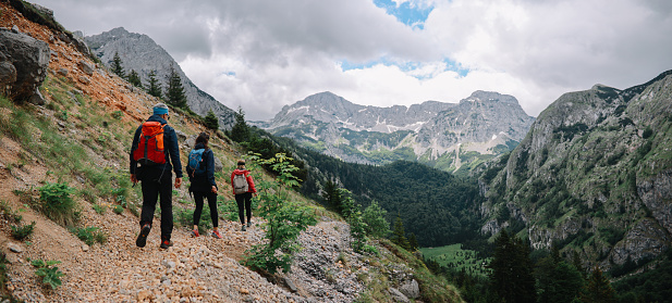 Group of people on a hiking trip through the mountains in Dinaric Alps, Southeastern Europe.