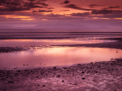 Barassie Shore Troon in Ayrshire Scotland with red moody sky on a summer night.
