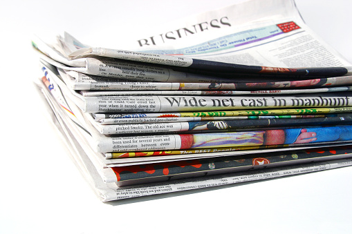 Newspapers, isolated, focus on front.
