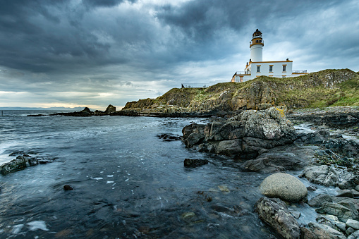 Rocky seascape at Turnberry point lighthouse with cloudy moody sky  at coast line