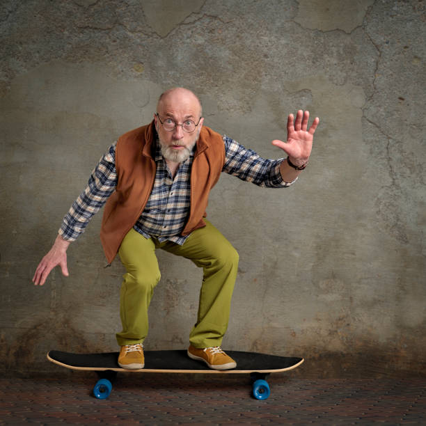 istock scared senior man with a long cruising skateboard 1395237199