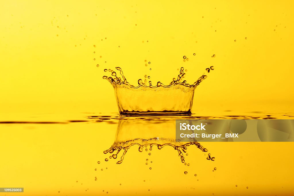 Splash in Yellow A splash of water in a yellow background. Back Lit Stock Photo