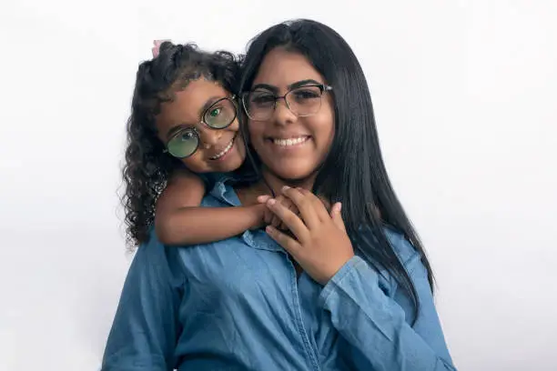 Photo of mother and daughter with glasses in studio photo on white background for cropping