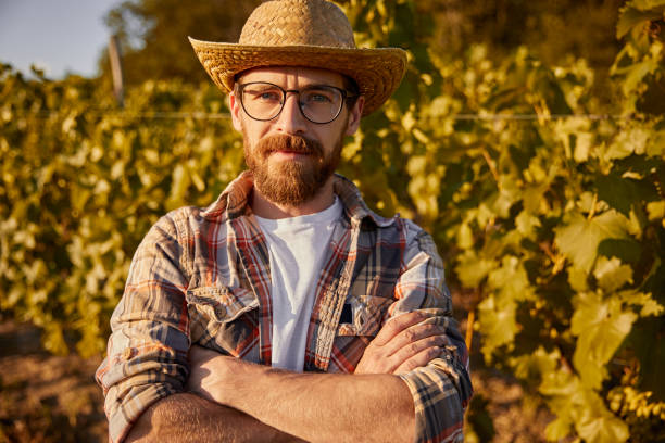 istock Confident farmer standing in vineyard 1395253608