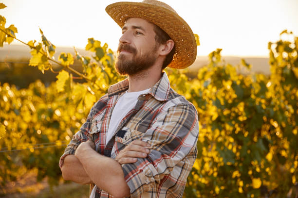 istock Confident farmer standing near grapevine 1395253617