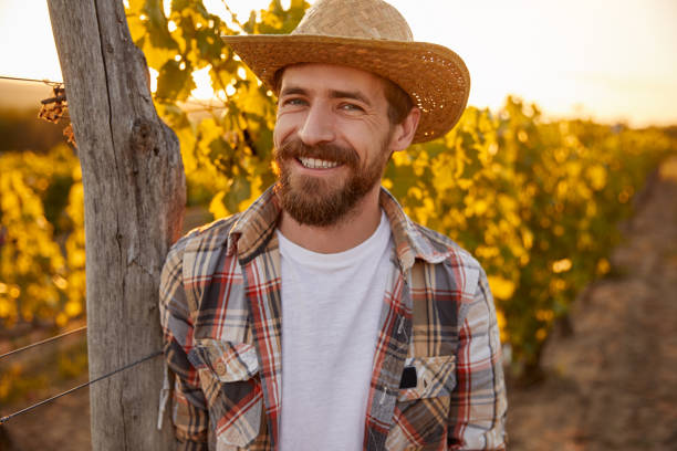 istock Smiling farm owner in vineyard 1395253633