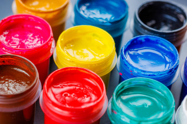 istock full-frame close-up background of opened small gouache paint jars 1395254143