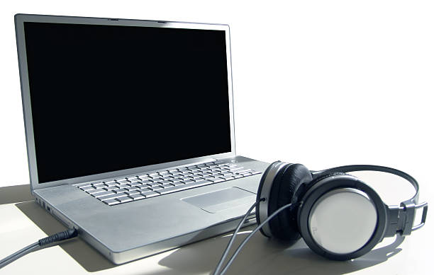 istock A laptop with a black screen and headphones by it 139525438