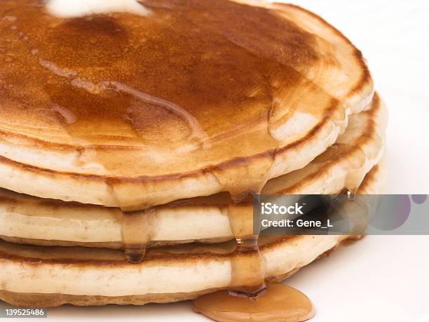 A Stack Of Pancakes With Maple Syrup Flowing On The Sides Stock Photo - Download Image Now