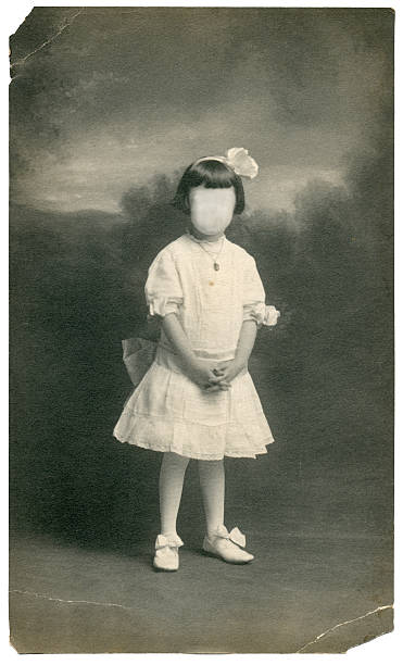Early 1900's portrait of young girl in fancy dress. Cloned out face.