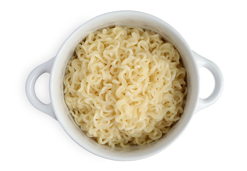 Closeup of Instant noodles in a white bowl isolated on white background with clipping path. Top view. Home cooking.
