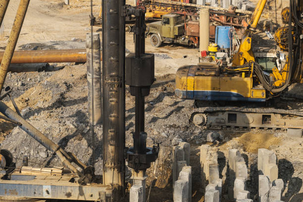 istock The pile driver hammers the pile. 1395264446