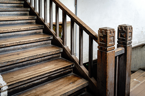 Abstract grungy interior, perspective view of a stairway going up, vertical photo