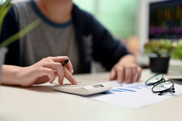 istock Female college student using calculator, doing her financial homework 1395266094