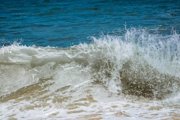 istock Breaking waves in the sunshine 1395266342