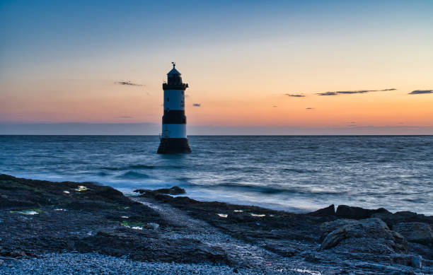 istock Penmon Point lighthouse at low tide, Penmon, Anglesey, Wales, Britain 1395269967