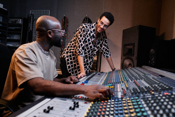 istock Cheerful Men Working In Recording Studio 1395271031