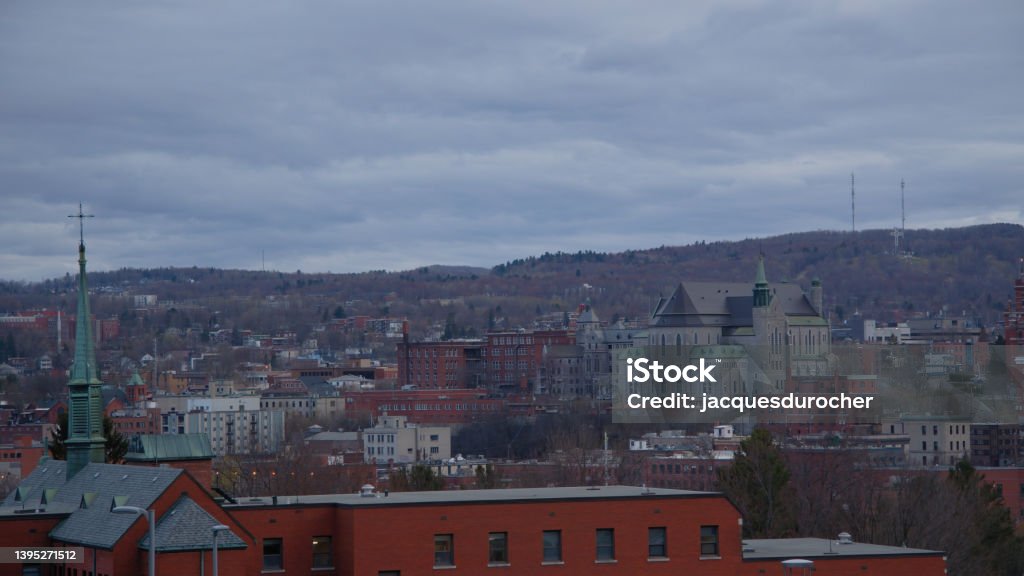 Sherbrooke small city in Quebec Estrie Eastern Townships cityscape downtown with church Small city landscape Sherbrooke Estrie Quebec Eastern Townships Canada downtown cathedral church clouds skyline Quebec Stock Photo