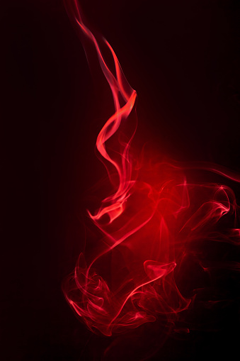 Red smoke motion on black background.