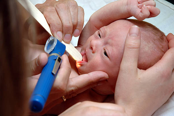 Examine baby´s mouth Doctor´s checkup of a baby looking in the mouth animal tongue stock pictures, royalty-free photos & images