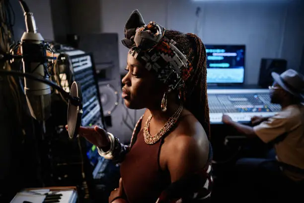 Photo of Young Woman In recording Studio